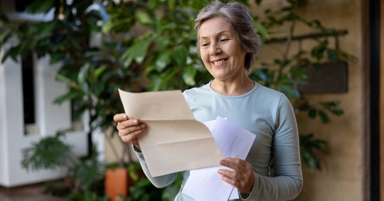 woman smiling looking at AC bill