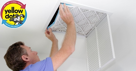 a man checking on HVAC air filter