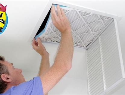 Person checking on HVAC air filter